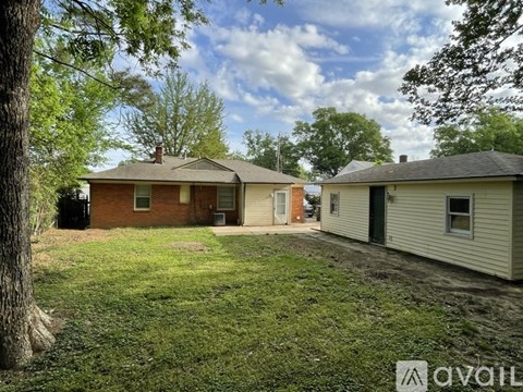 Two houses with a grassy area in between.