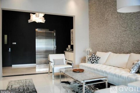 A modern living room with a white sofa and a glass coffee table.