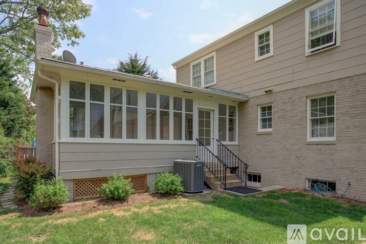 A house with a beige exterior and a white door is for sale.