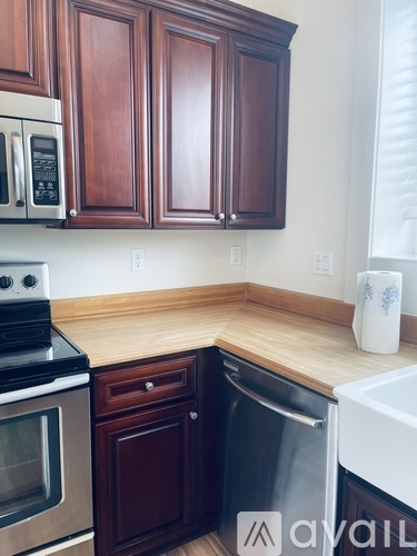 A kitchen with wooden cabinets and a white oven.