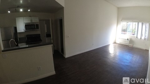 A kitchen with white cabinets and a black countertop is visible.