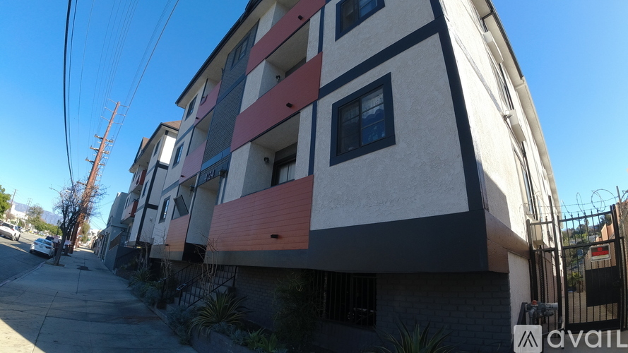 A modern apartment building with a clear blue sky in the background.