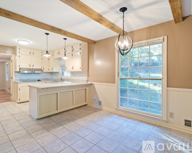 A kitchen with a large island and a window.