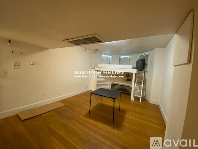 A room with a table and a ladder in it.