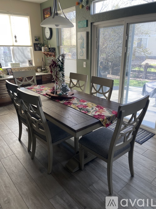 A dining room with a table set for four.