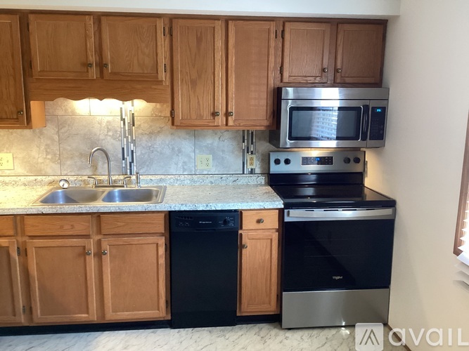 A kitchen with wooden cabinets and stainless steel appliances.