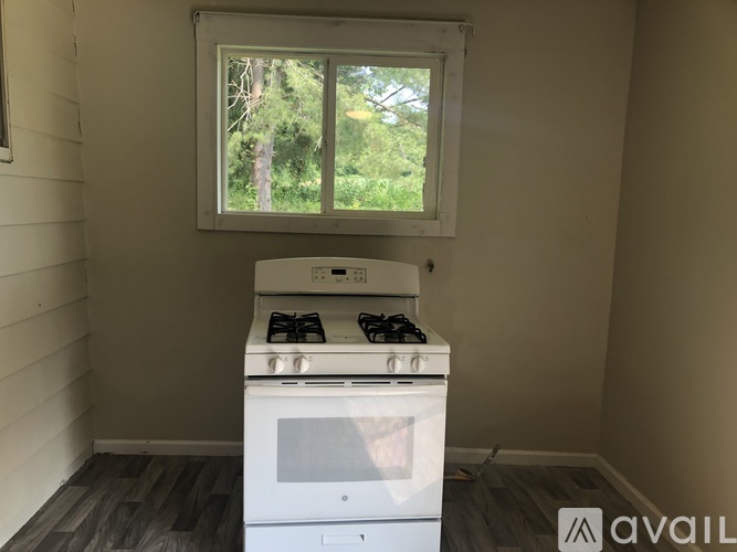 A white stove is in a room with a window.