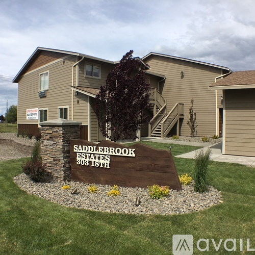 A sign in front of a house that says Saddlebrook Estates.