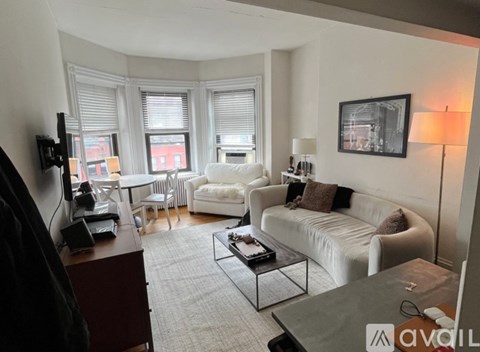 A living room with a white couch and a coffee table.