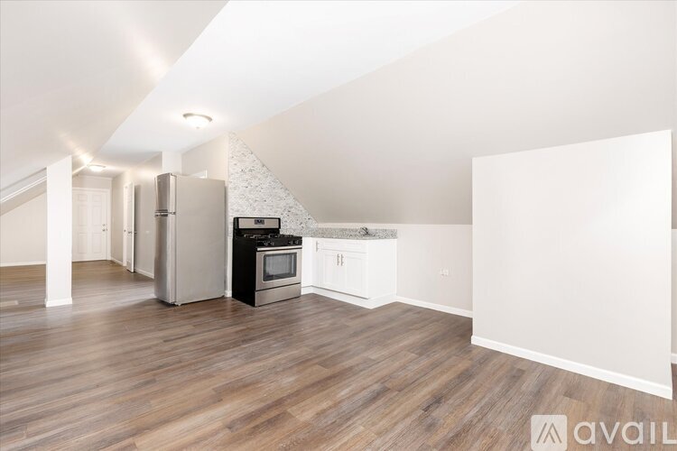 A kitchen with a refrigerator, oven, and microwave.