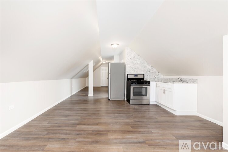 A kitchen with a stove top oven and a refrigerator.