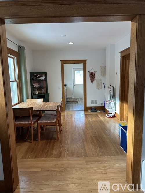 A dining room with a wooden table and chairs.