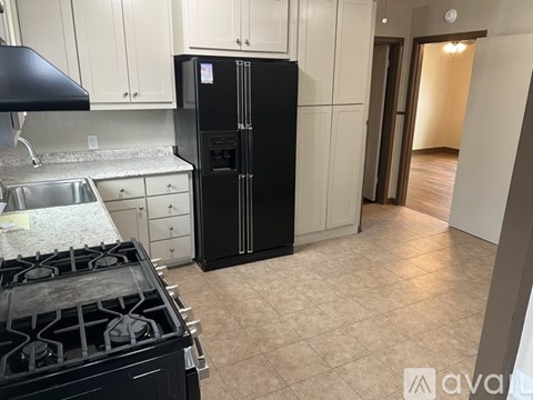 A kitchen with a black fridge and stove.