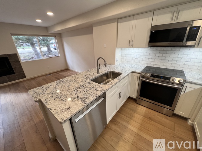 A kitchen with granite countertops and stainless steel appliances.