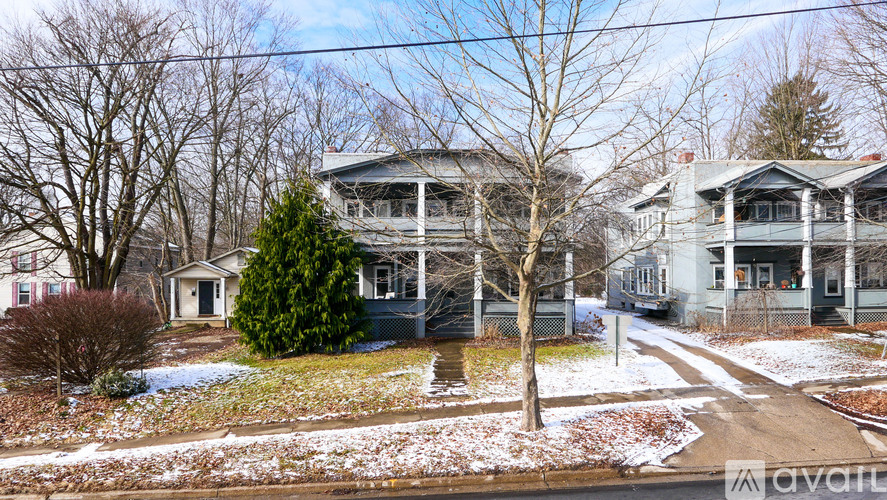 A house with a tree in front of it.