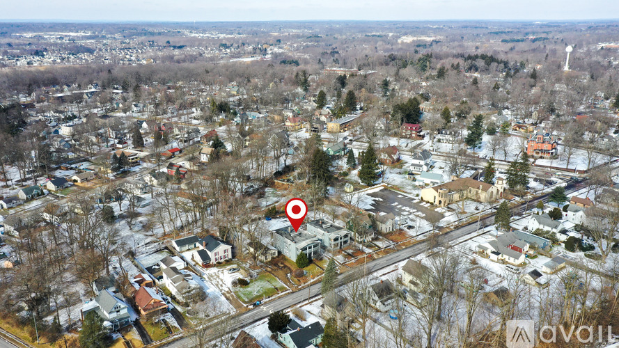 A bird's eye view of a residential area with a red marker indicating a specific location.