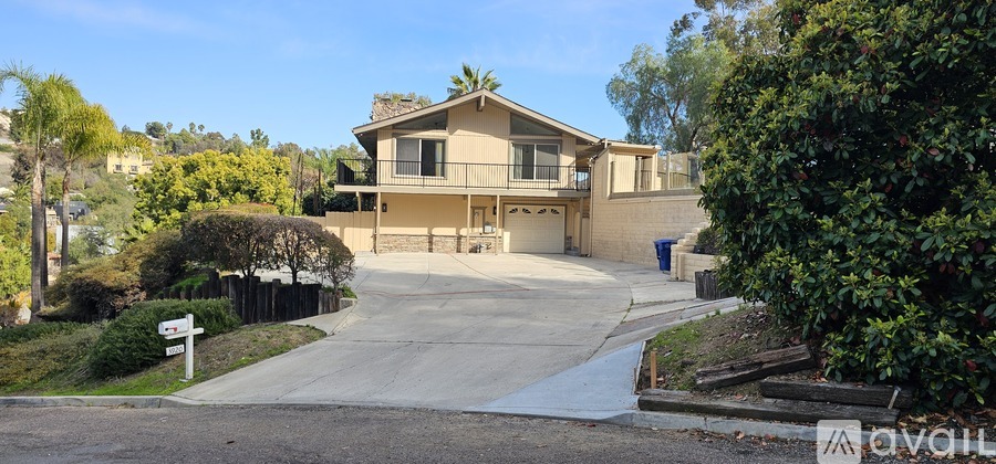 A house with a driveway and a sign that says "available".