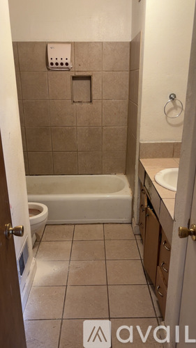 A bathroom with a toilet, tub, and sink.