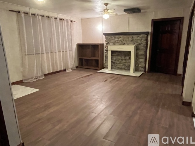 A living room with a fireplace and a television.
