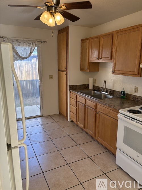 A kitchen with wooden cabinets and a white refrigerator.