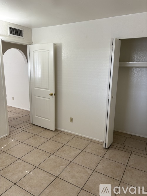 A room with a white door and a white wall.