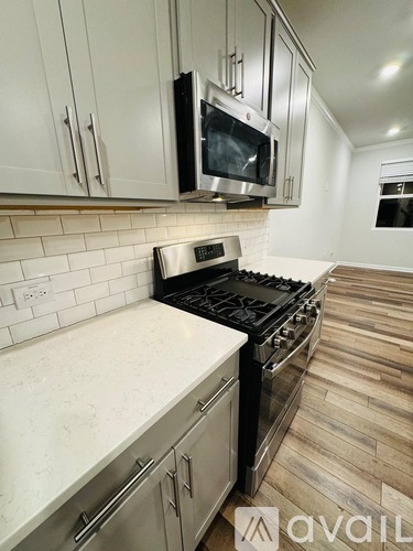 A kitchen with a stove top oven and a microwave above it.