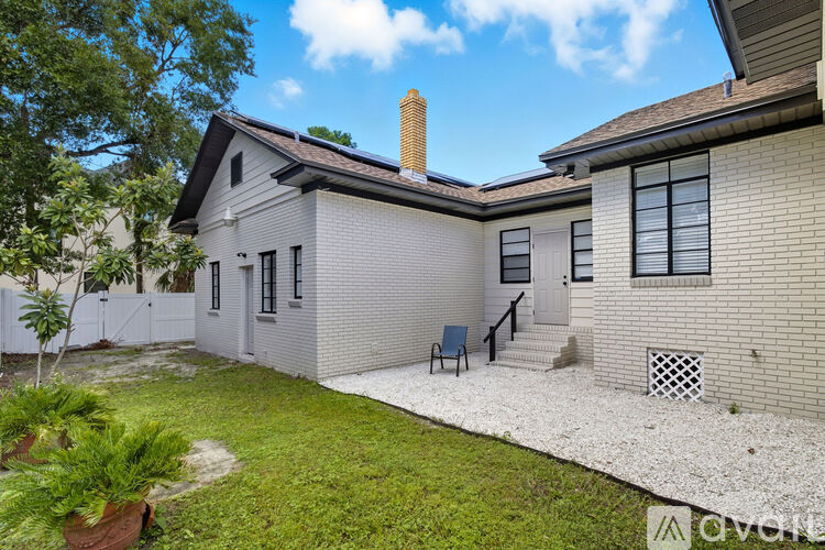 A house with a white exterior and a small front yard.