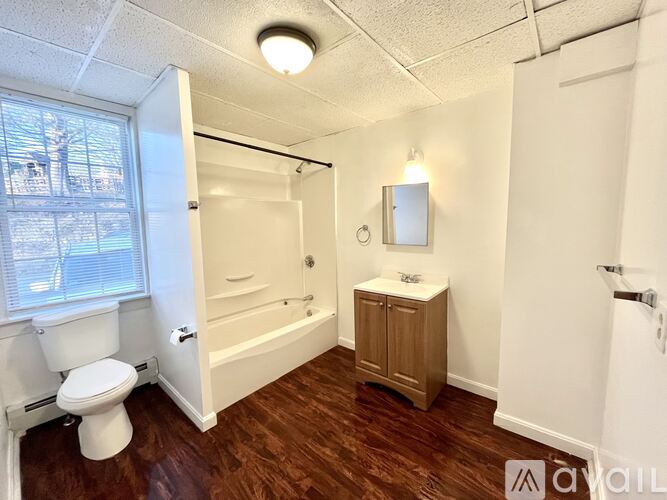 A small bathroom with a toilet, sink, and bathtub.