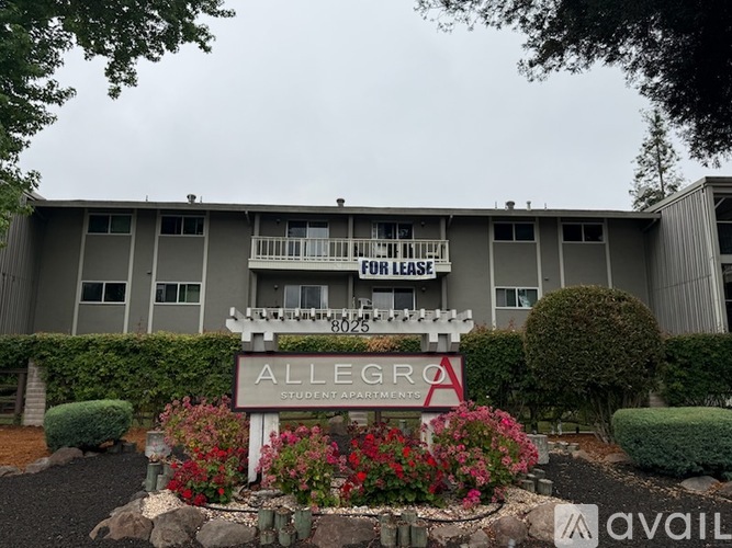 A building with a sign that says "ALLEGRO STUDENT APARTMENTS" in front of it.