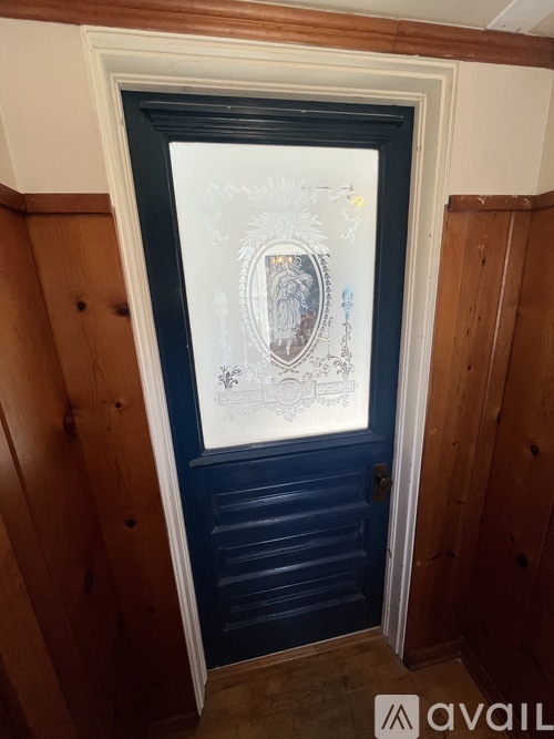 A door with a glass window and a painting on it.