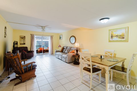 A living room with a dining table and chairs.