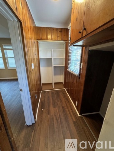 A room with wooden floors and a white radiator.