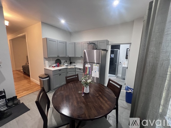 A kitchen with a table and chairs in the foreground.