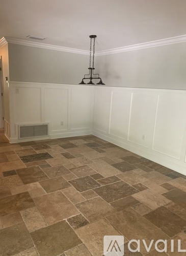 A room with a tiled floor and a chandelier.