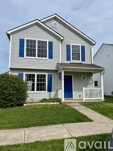 A house with blue shutters and a blue door.