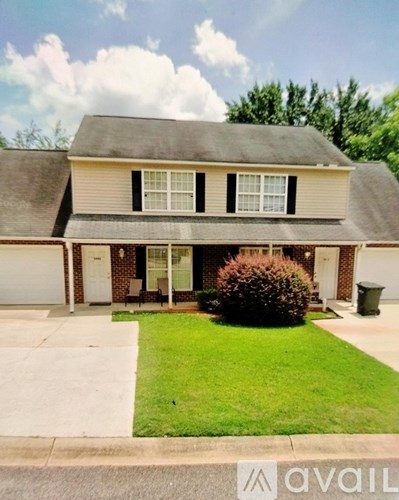A house with a brown roof and a white garage door.