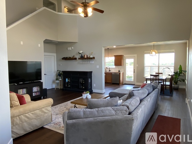 A living room with a grey couch and a television.