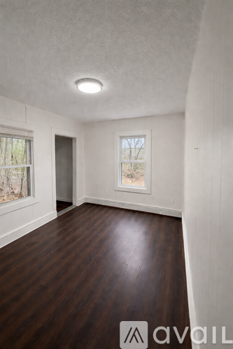 A room with wooden floors and a window.