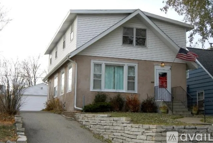 A house with a red door and a flag on the roof.