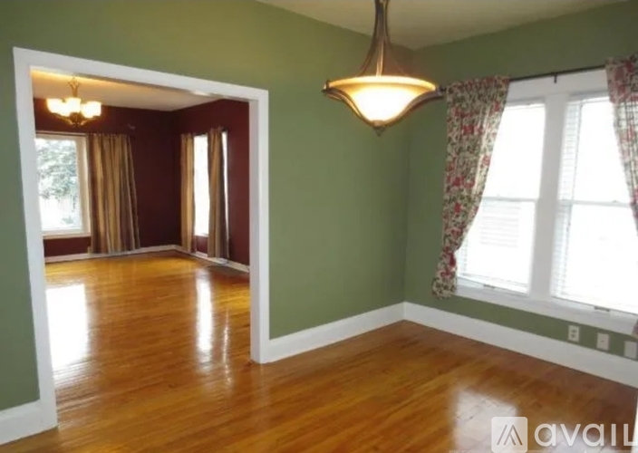A room with green walls and wooden floors.