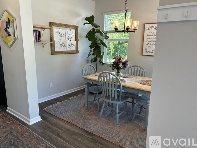 A dining room with a table and chairs.