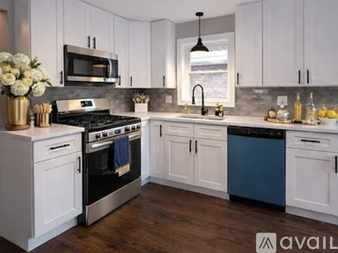 A kitchen with white cabinets and a black stove top.