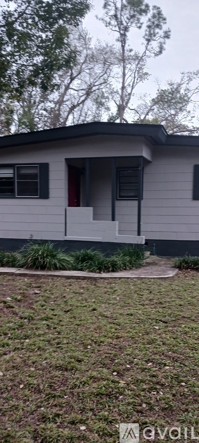 A house with a red door and a small porch.