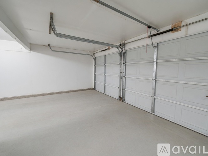 A spacious garage with white walls and a concrete floor.