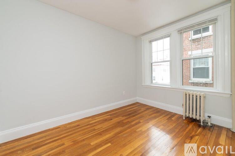 A room with wooden floors and a window.