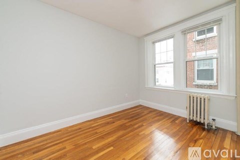 A room with wooden floors and a window.