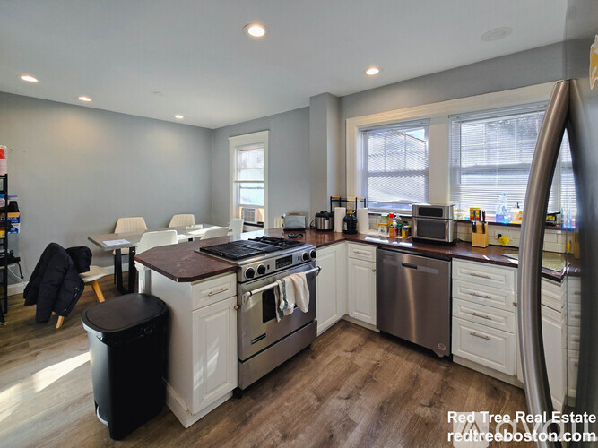 A kitchen with a stove top oven and a dishwasher.