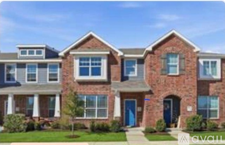 A row of houses with blue doors and windows.