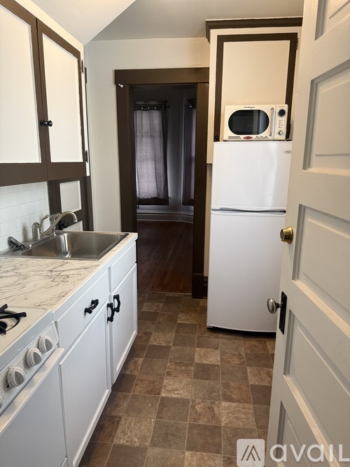 A kitchen with a white fridge and a white stove.