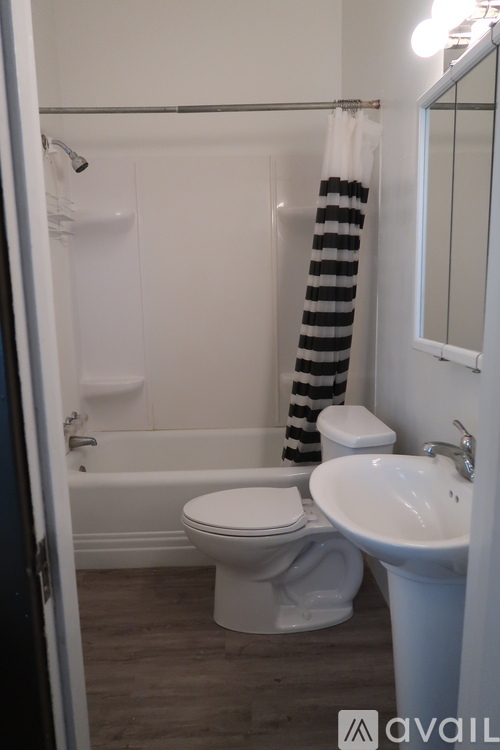 A bathroom with a toilet, sink, and a striped towel.